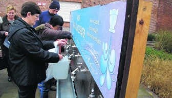 Bij het gemeentehuis in Niel kon aan kraantjes drinkbaar leidingwater worden geput.lkw
