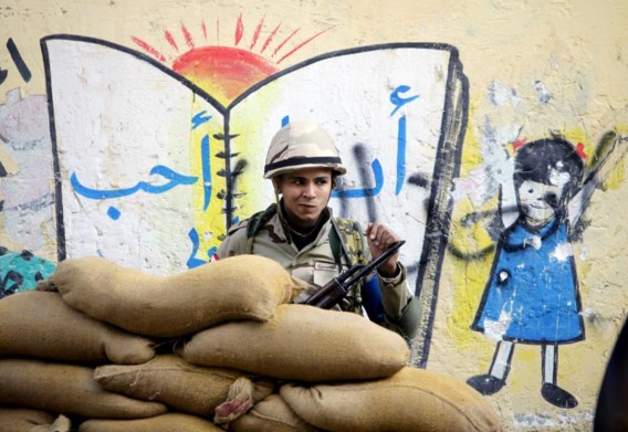 Een jonge Egyptische soldaat houdt de wacht achter zandzakjes voor een stembureau in een schooltje in Caïro. Na de coup tegen de verkozen president Morsi, lid van de Moslimbroederschap, moeten de Egyptenaren bij referendum een nieuwe grondwet goedkeuren. Stemmen ze ‘ja’, dan zal sterke man generaal Sisi dat zien als een volksbesluit om hem op de faraotroon te hijsen.